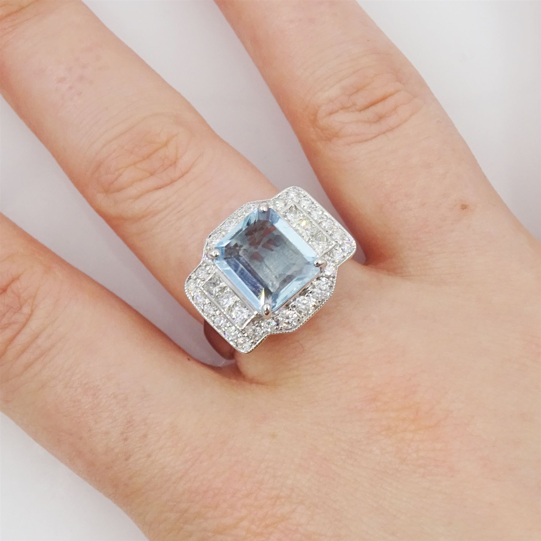 18ct white gold aquamarine and diamond ring, emerald cut aquamarine with princess cut and round brilliant cut diamond surround, stamped 750, aquamarine approx 2.45 carat, total diamond weight approx 0.90 carat