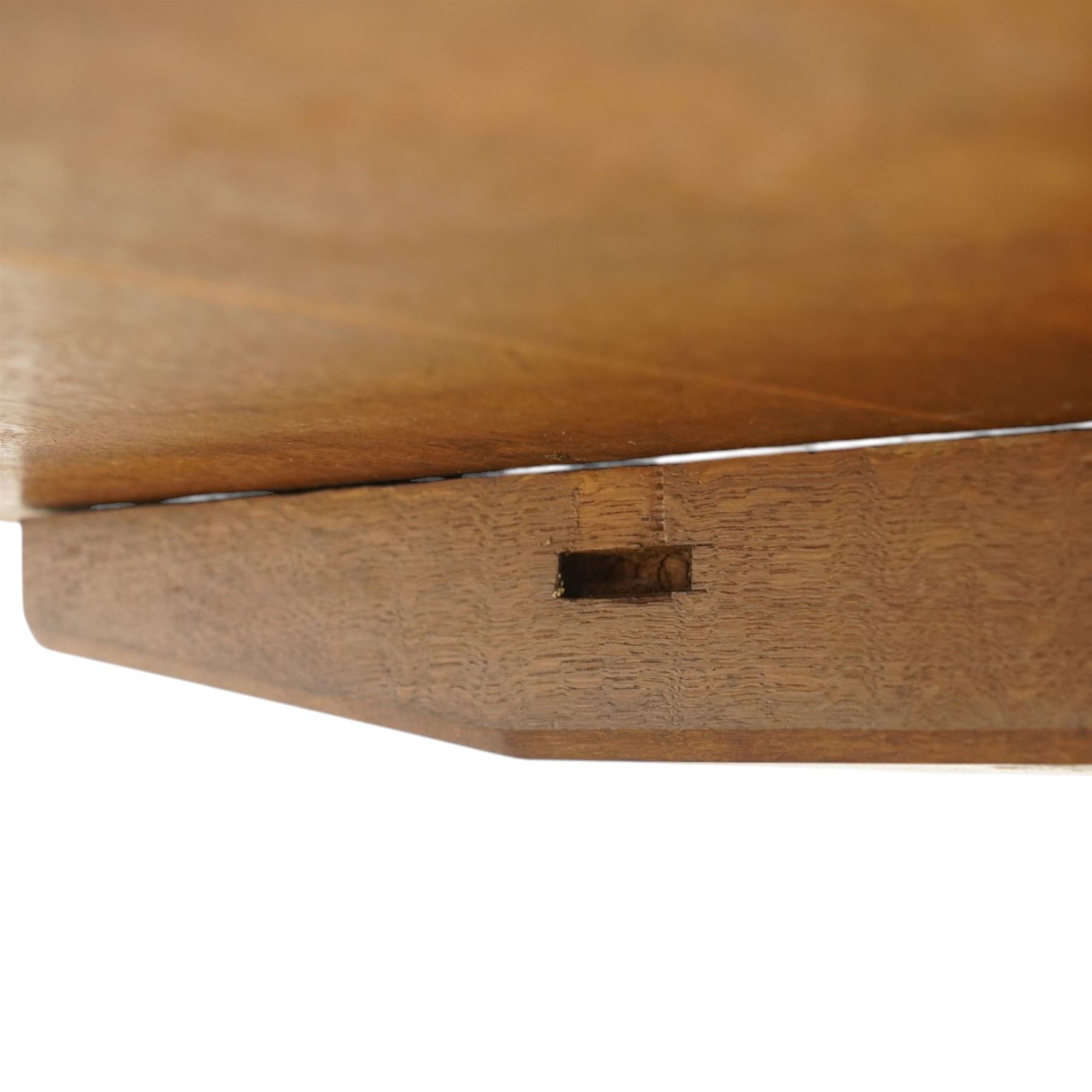 Acornman - 5' adzed oak dining table, rectangular top above a trestle base united by a stretcher with carved acorn signature, by the workshop of Alan Grainger of Brandsby