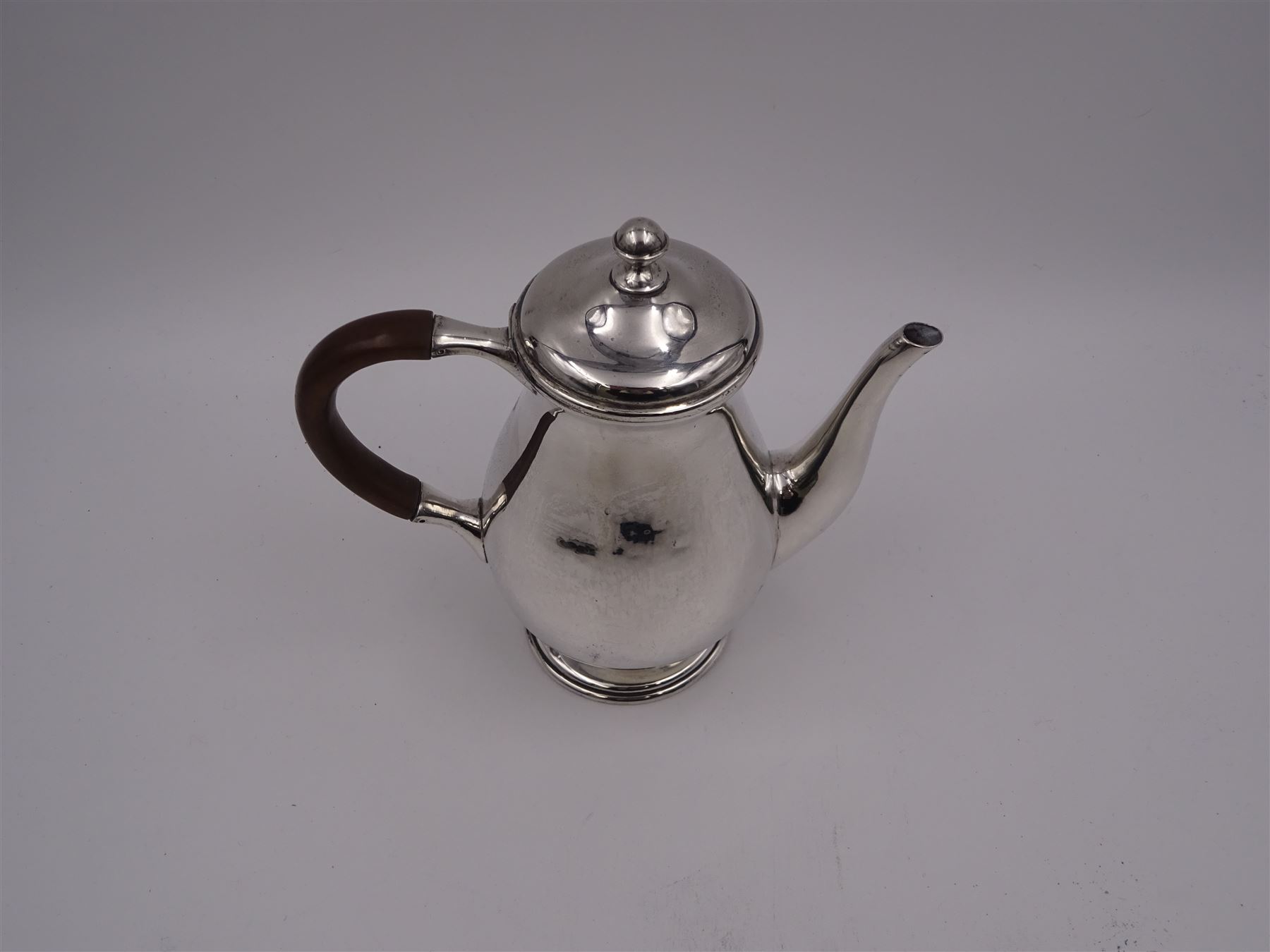 Liberty & Co 1930s small silver coffee pot, of plain baluster form, with brown Bakelite C handle with trefid mounts and cover with spherical knopped finial, upon circular stepped foot, hallmarked Liberty & Co, Birmingham 1934