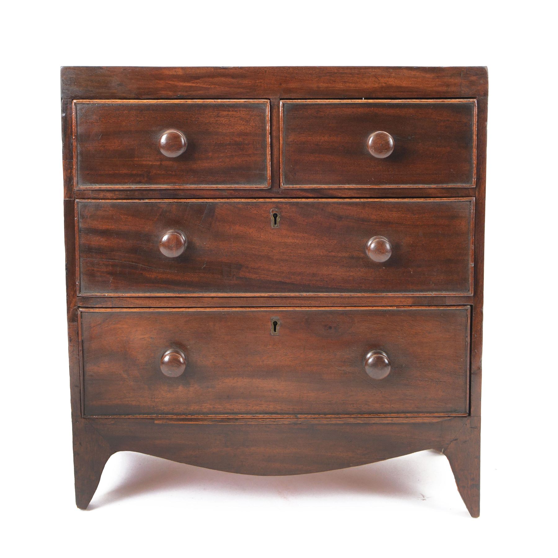 Victorian mahogany 'apprentice piece' miniature chest, rectangular top over two short and two long cock-beaded drawers with turned handles, shaped apron and bracket feet 