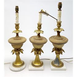 Three table lamps, of urn form with acanthus detail, two upon square base, the other upon circular base, (a/f), approximately H56cm, together with a pair of cream lace lampshades. 