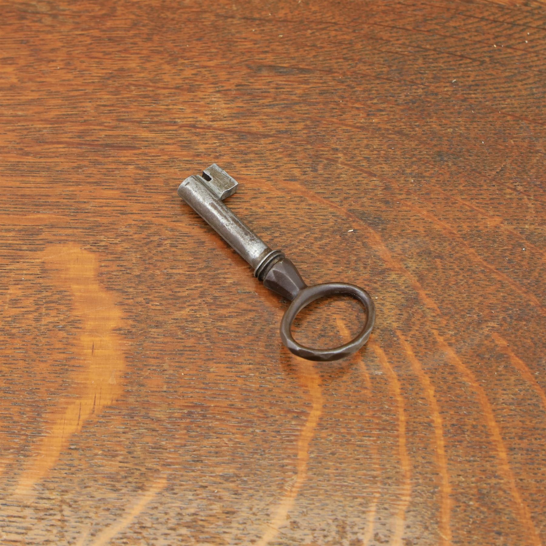 Late 19th century French provincial oak chest of drawers, moulded rectangular top with carved rope edge over four graduated long drawers with raised and fielded panels and ornate cast handles, canted angles and shaped apron below, standing on moulded block feet,