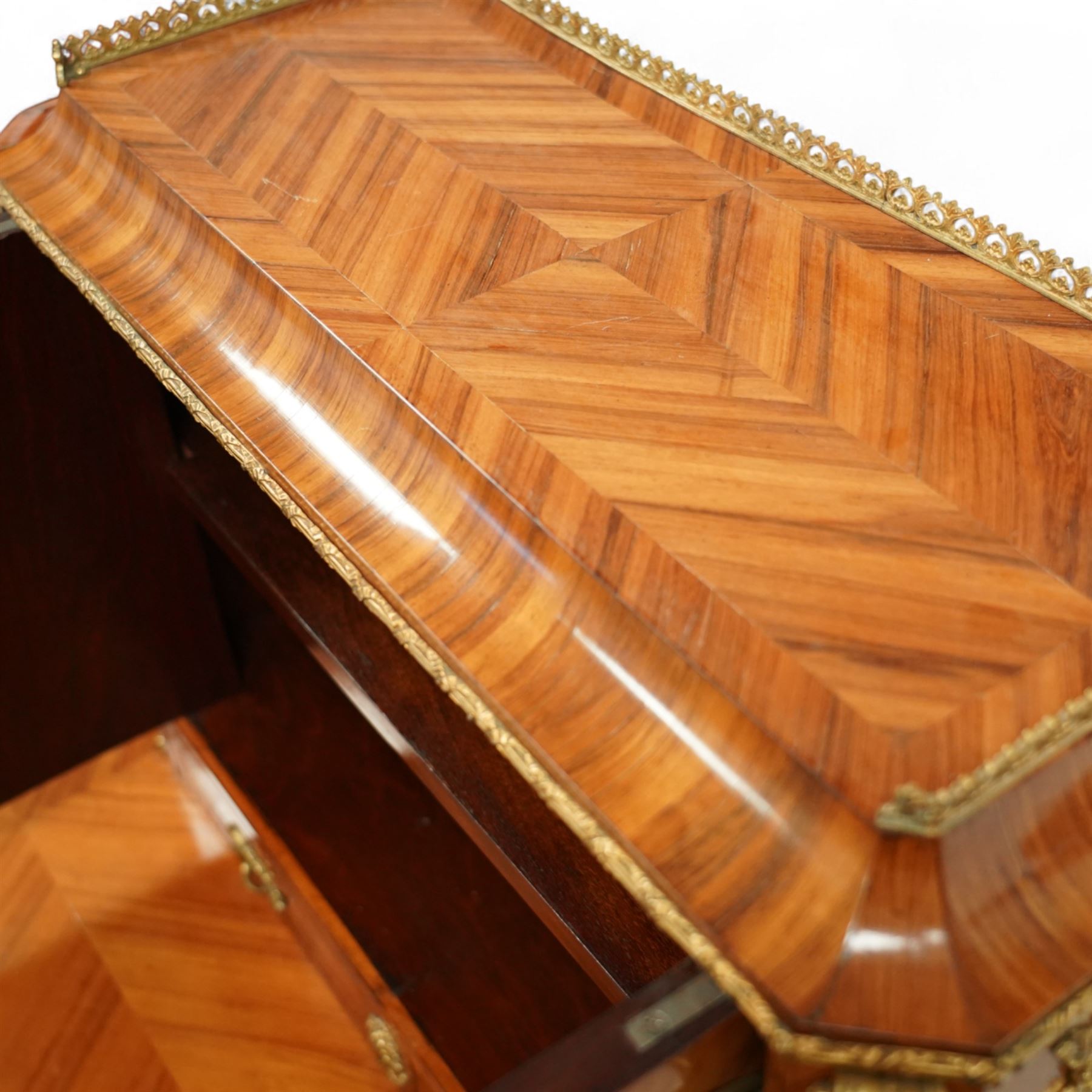 Late 19th century French Louis XV style kingwood and ormolu mounted bonheur du jour, the upper section with a pierced three-quarter gallery over a pair of cupboard doors inset with Sèvres-style porcelain portrait plaques, enclosing a shelved interior over two short drawers, the serpentine top and apron richly mounted with gilt-bronze foliate and scroll motifs, single frieze drawer below on cabriole supports with acanthus cast sabots