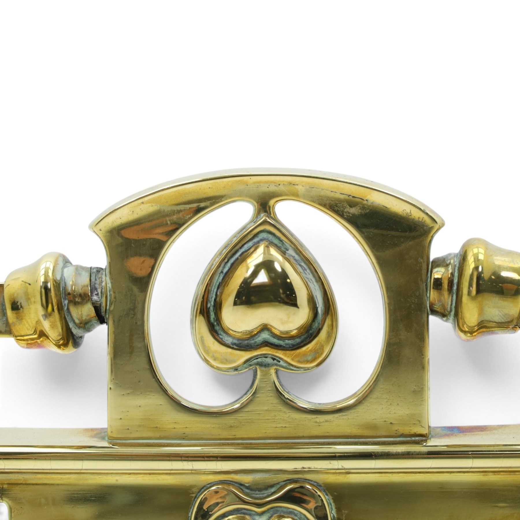 Two Edwardian brass fire curbs, comprising a decorative example with pierced vertical frieze, applied Tulips (H 21cm, W 126cm, D 32cm), together with a hammered moulded example with acanthus corners (H 12cm, W 138cm, D 37cm)
