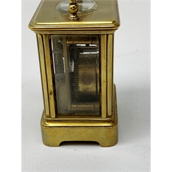 A brass cased miniature carriage clock, the white enamel dial with black Roman numerals, H7cm. 