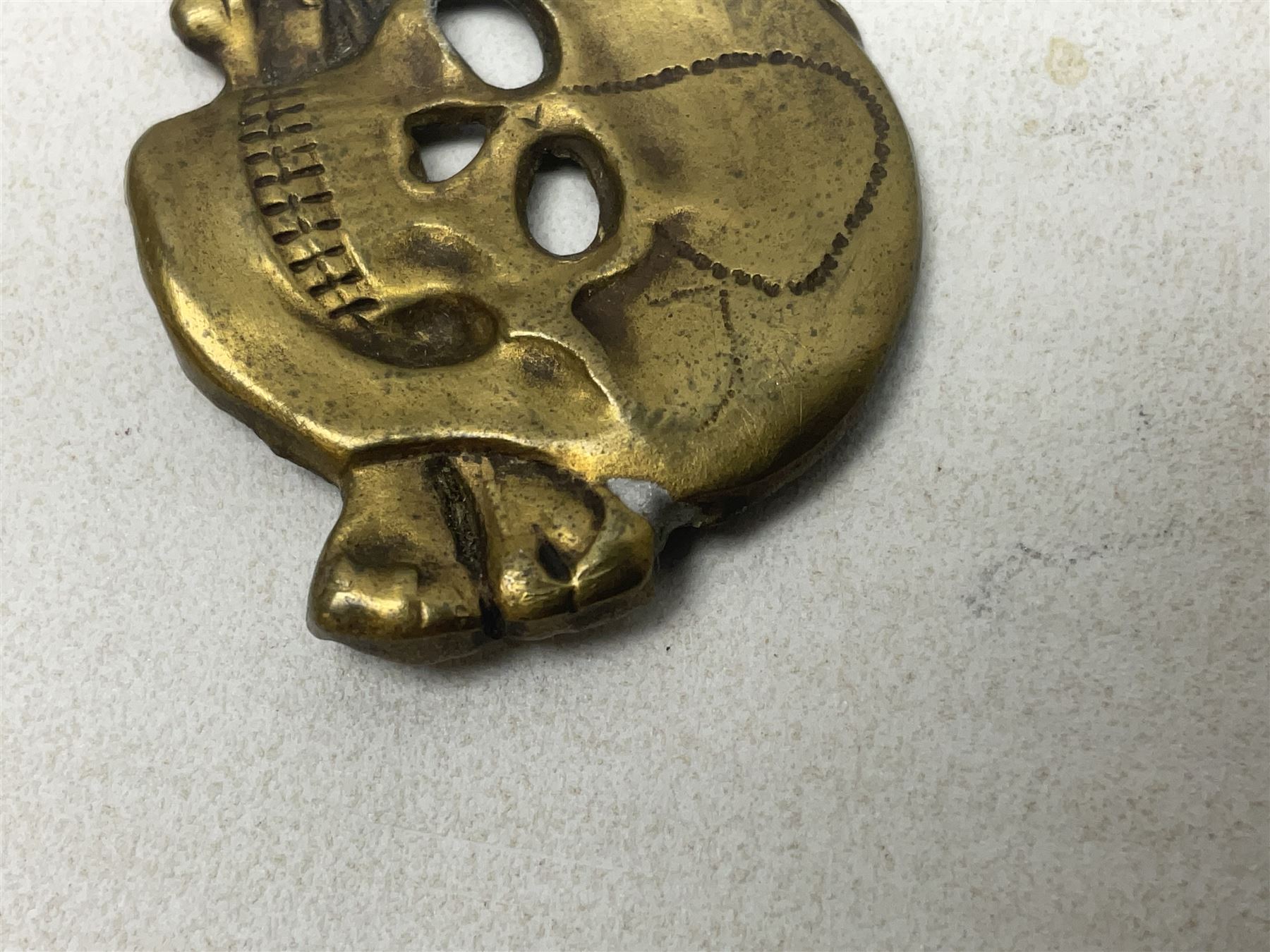 Two WW2 German 'SS' visor cap skull badges and another later; and visor cap eagle insignia (4)