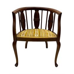 Late Victorian mahogany framed tub chair, rounded backrest with vertical splats and three carved oval medallions, upholstered seat in yellow patterned fabric, on cabriole supports