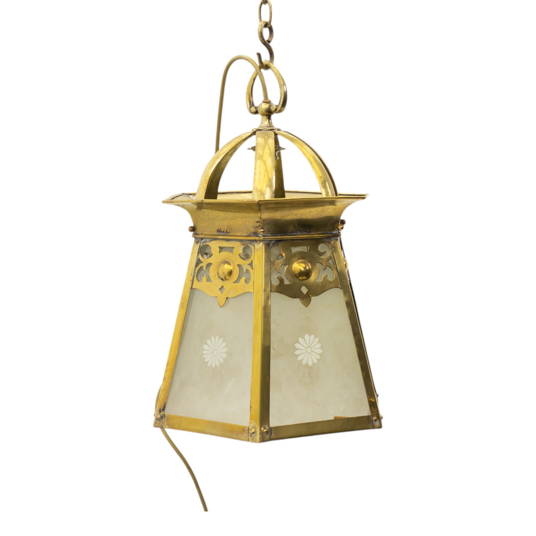 Arts & Crafts brass hall lantern, circa 1900, of hexagonal tapering form with open dome top support and pierced foliate detail above frosted glass panels with flower head detail, H41.5cm D29cm