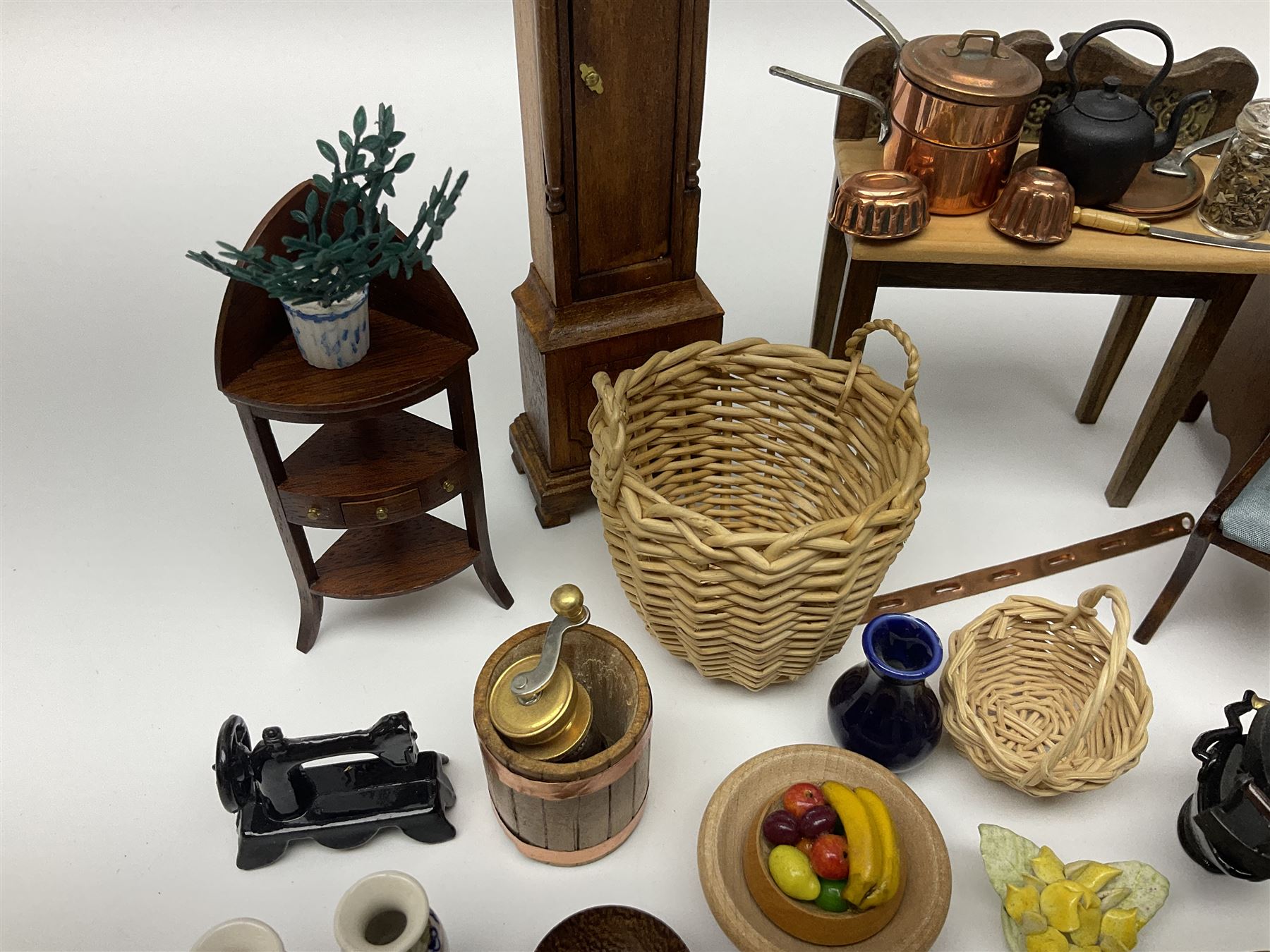 Collection of miniature dolls house furniture and accessories, to include long case clock, chest of drawers, tiled wash stand, ceramics and glass ware, mirror, baskets, etc 