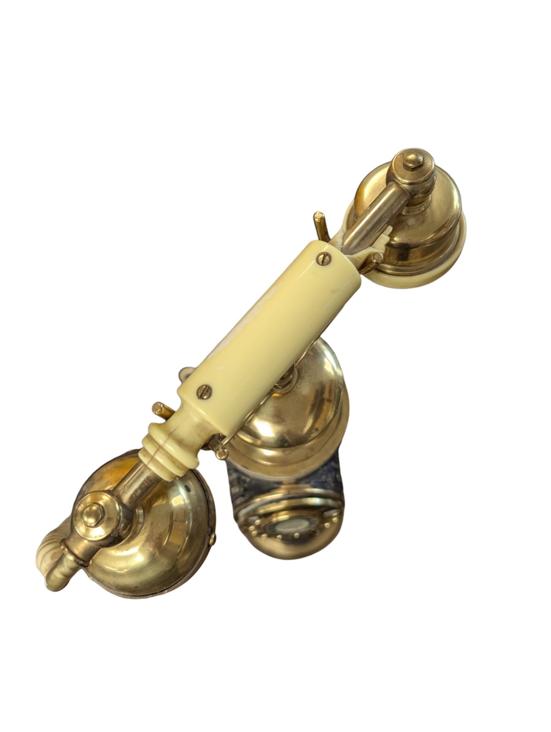 Tall Eastern brass and marble telephone, H105cm