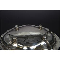 Early 20th century silver swing handled basket, of oval form with shaped rim and upon four bun feet, hallmarked C W Fletcher & Son Ltd, London 1918