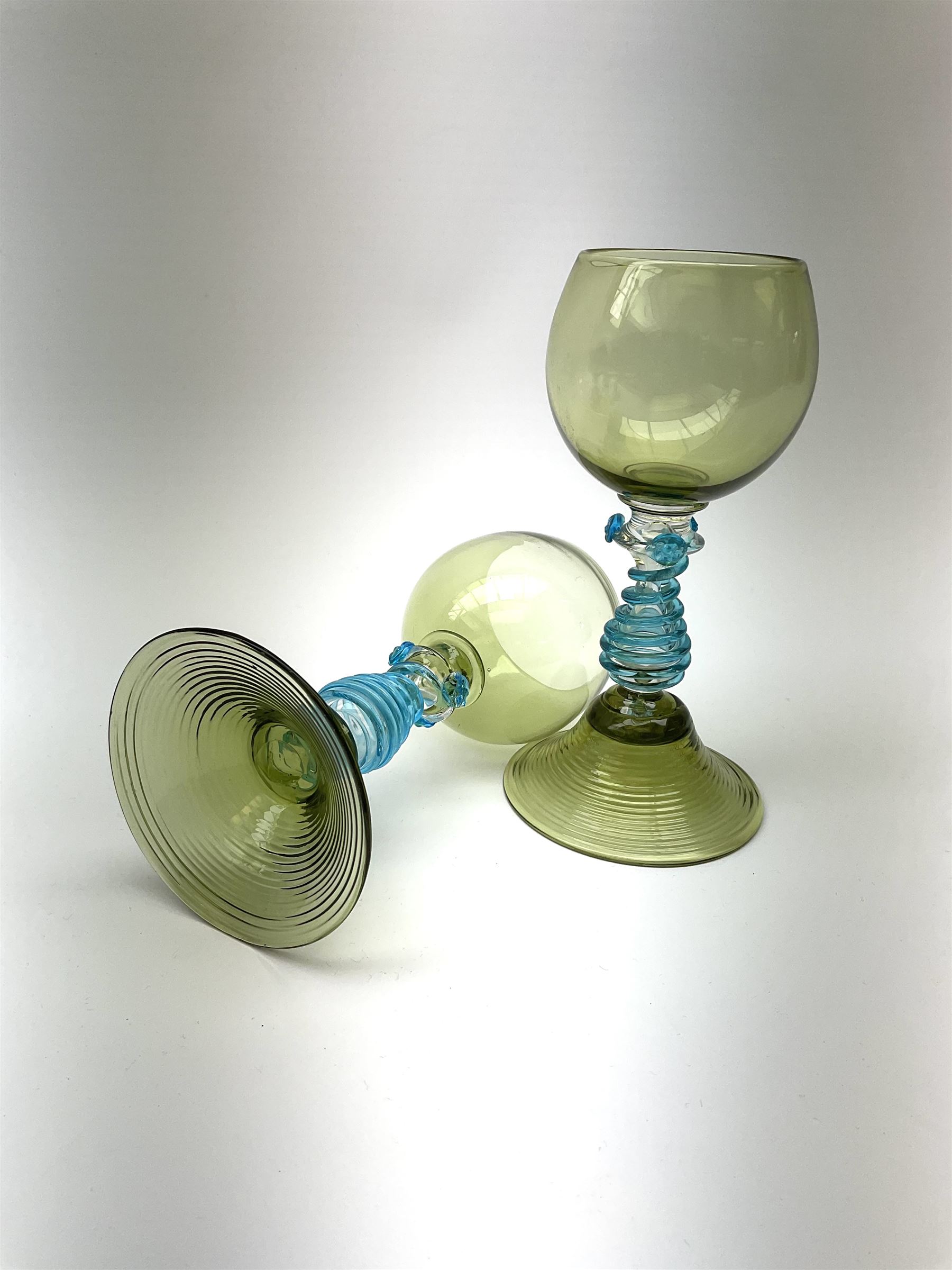 A set of eight German green glass hock glasses, with trailed spiral and