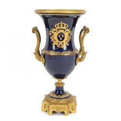 19th century Sevres style ormolu mounted porcelain twin handled urn, the body decorated with a gilt crowned crest of three fleur de lis against a cobalt ground, with spurious Sevres mark beneath, H26cm
