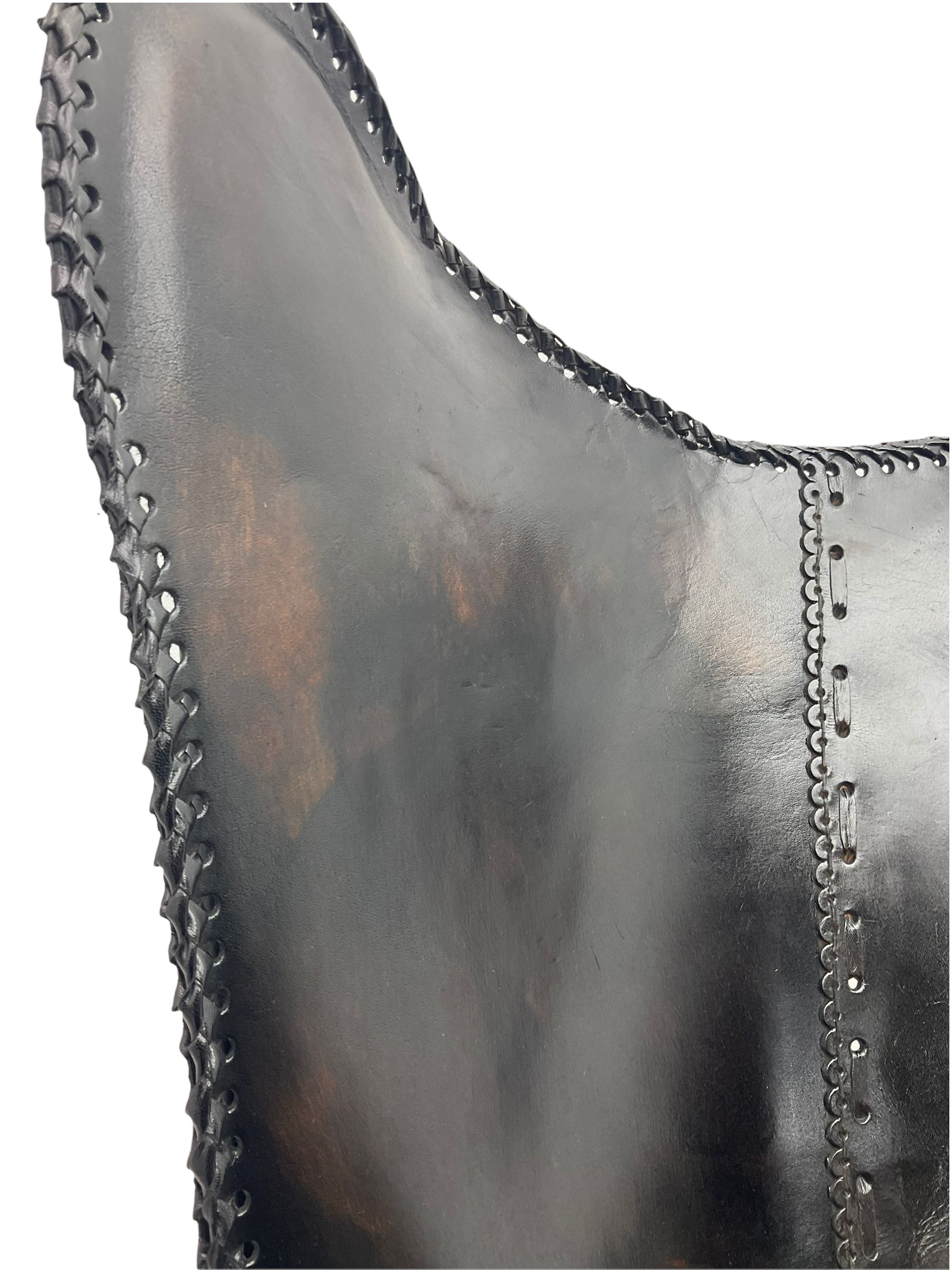 Metal framed butterfly chair upholstered in slung dark tan stitched leather 
