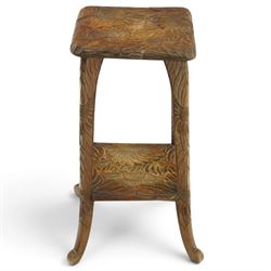 Attrib. Liberty & Co. - Arts & Crafts carved Japanese pattern two-tier occasional table, the square top with rounded corners heavily carved foliate motifs, raised on tapering supports with scroll feet united by undertier