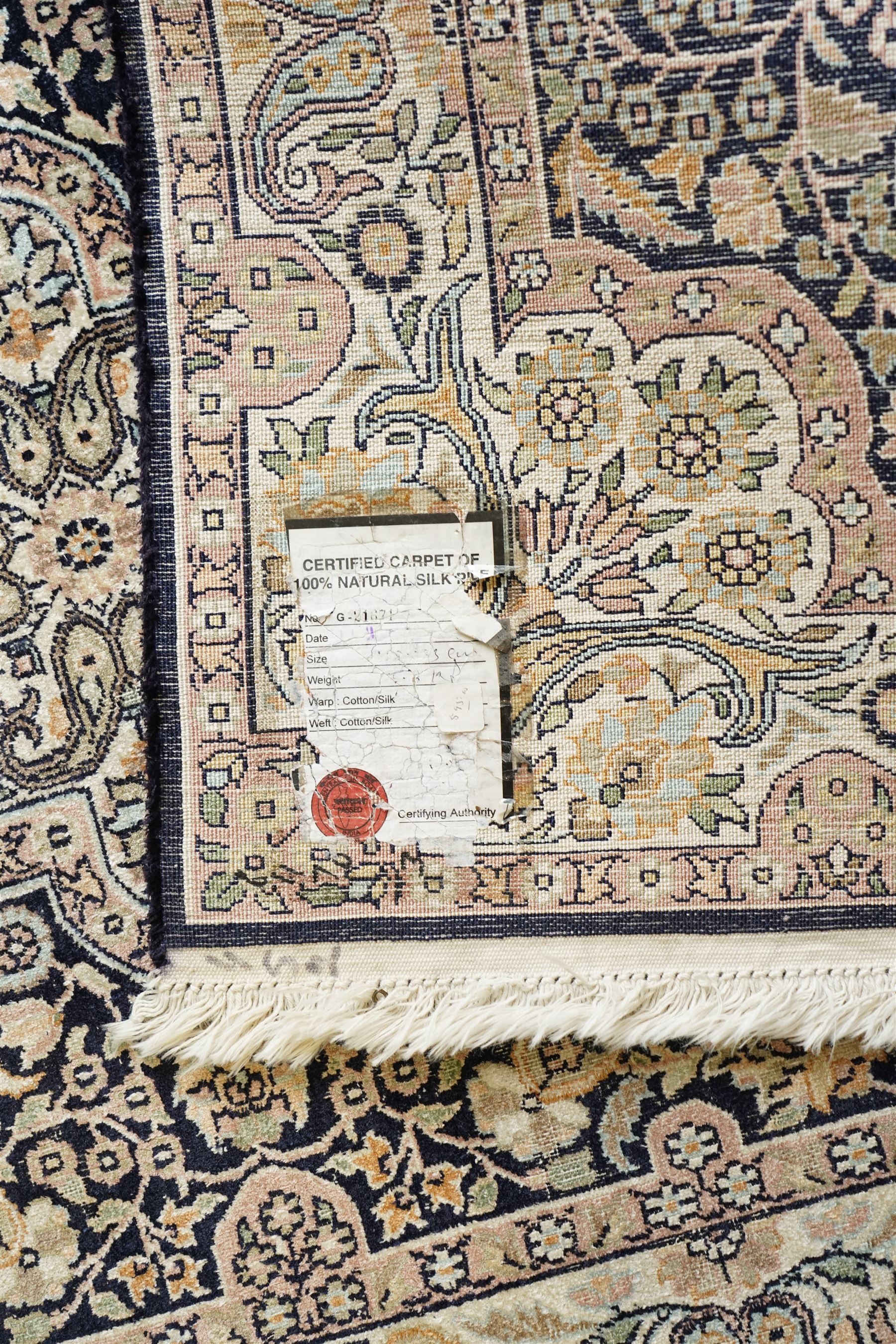 Persian style rug, central medallion with symmetrical floral arabesques, complex and layered borders featuring flowers and scrolling vinework