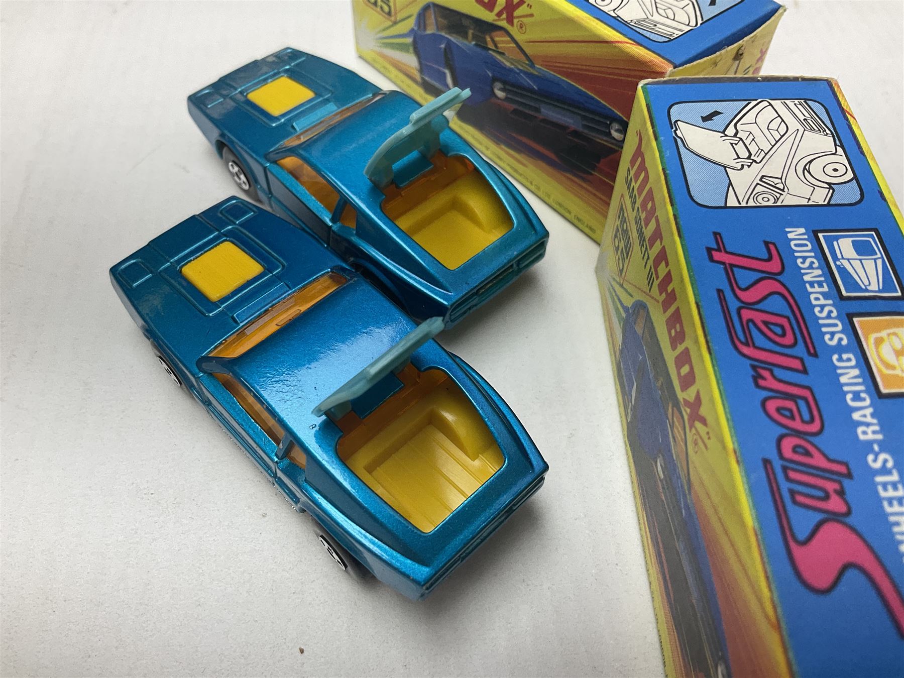 Matchbox 1-75 Series 'Superfast' ex-shop stock - eight models comprising two 62d Dragster, two 64c Slingshot Dragster, two 65d Saab Sonnet III and two 75c Alfa Carabo; all boxed; together with Matchbox trade catalogue c1973 in original vinyl cover (9)