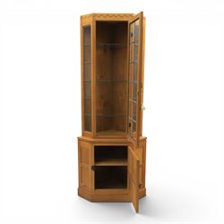 Mouseman - oak floor standing corner cabinet, scalloped cornice above a leaded glass cabinet, blackened metal hinges and latches, with carved mouse by the workshop of Robert Thompson of Kilburn