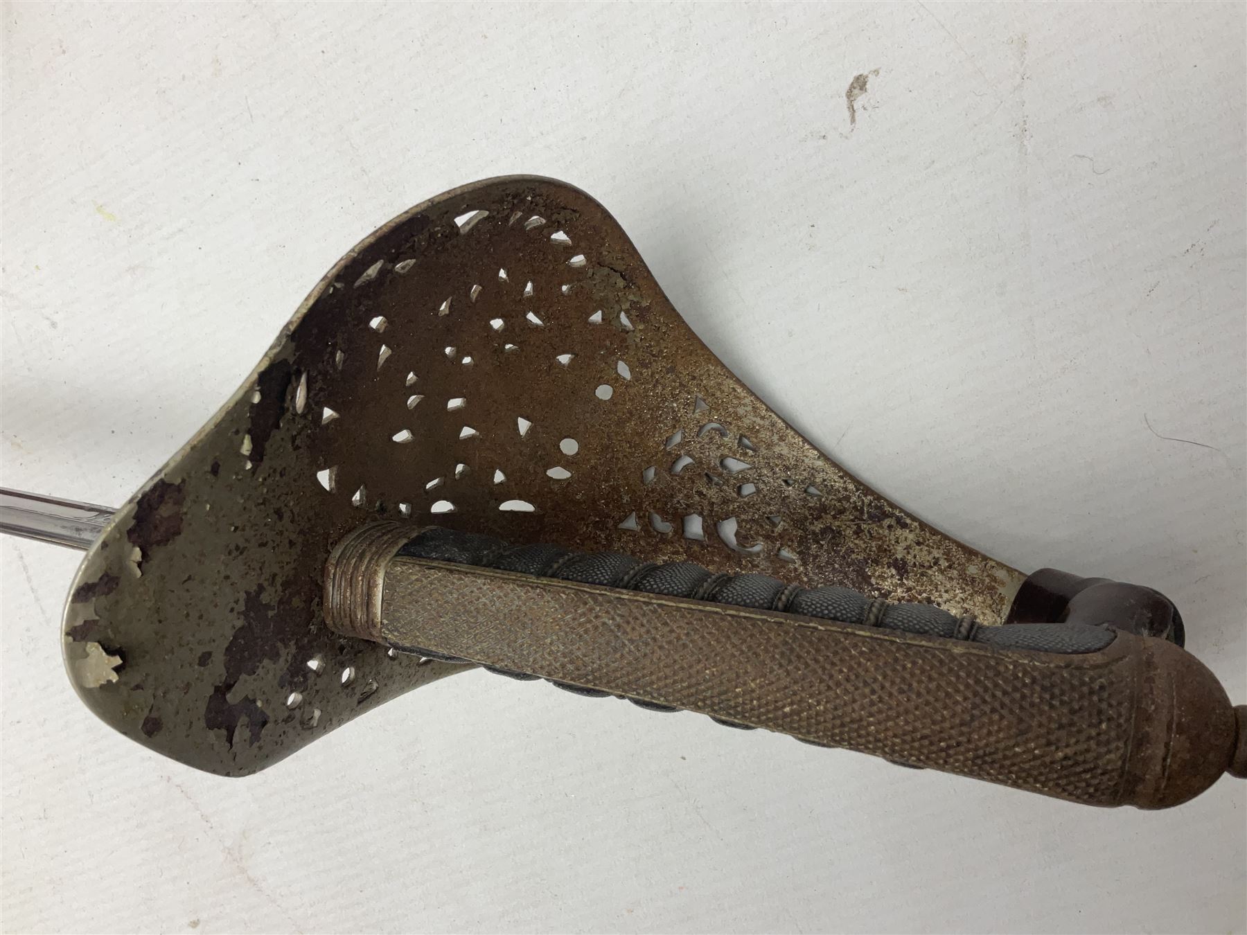 George V 1897 pattern Army Officer's sword by Henry Wilkinson Pall Mall London, the 82.5cm 'London Made' blade etched to both sides with Royal Crests and cyphers etc, pierced half-basket hilt with wire-bound fish skin grip and remains of leather knot strap; in leather covered field service scabbard L101cm overall; and two 14th Prince of Wales Own swagger sticks (3)