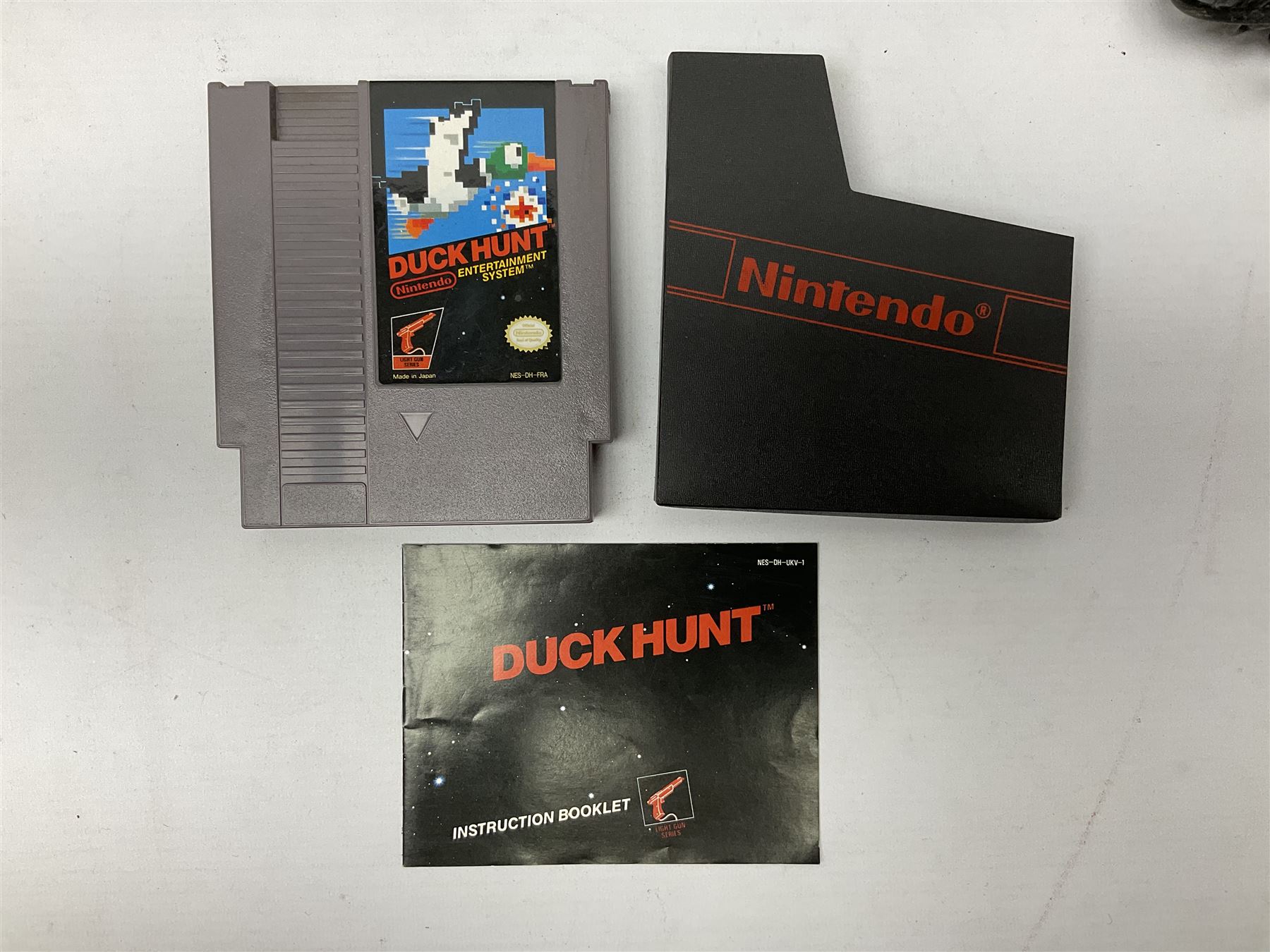 Nintendo Entertainment System (1985) console with two controllers, accessories and instruction booklet. NES Games ‘Duck Hunt’ with Nintendo Zapper gun, ‘Pinball’ and ‘Super Mario Bros.’, all with original sleeves and instruction booklets. NES game ‘Super Mario Bros. 2’ cartridge only