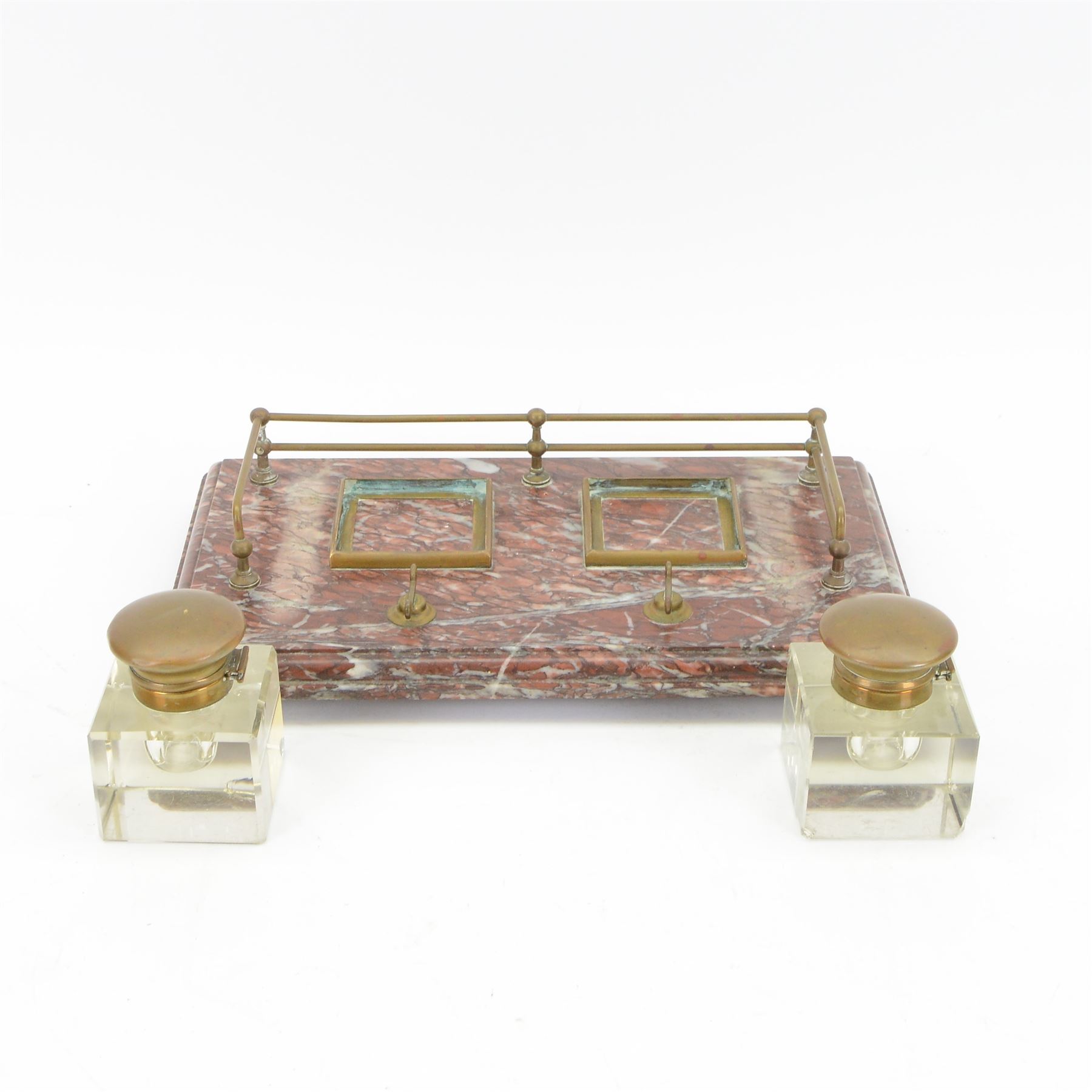 Victorian brass metal mounted red marble inkstand, the stepped rectangular base raised upon bun feet, complete with two glass ink bottles with hinged lids, H12cm