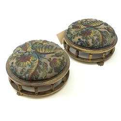 A pair of Victorian needle and beadwork footstools within a gilded frame raised upon three paw feet, H12.5cm D26cm.  