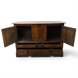 18th century oak hall cupboard, rectangular top with moulded edge, over two panelled hutch-cupboards, the base fitted with six assorted drawers, on large bracket feet