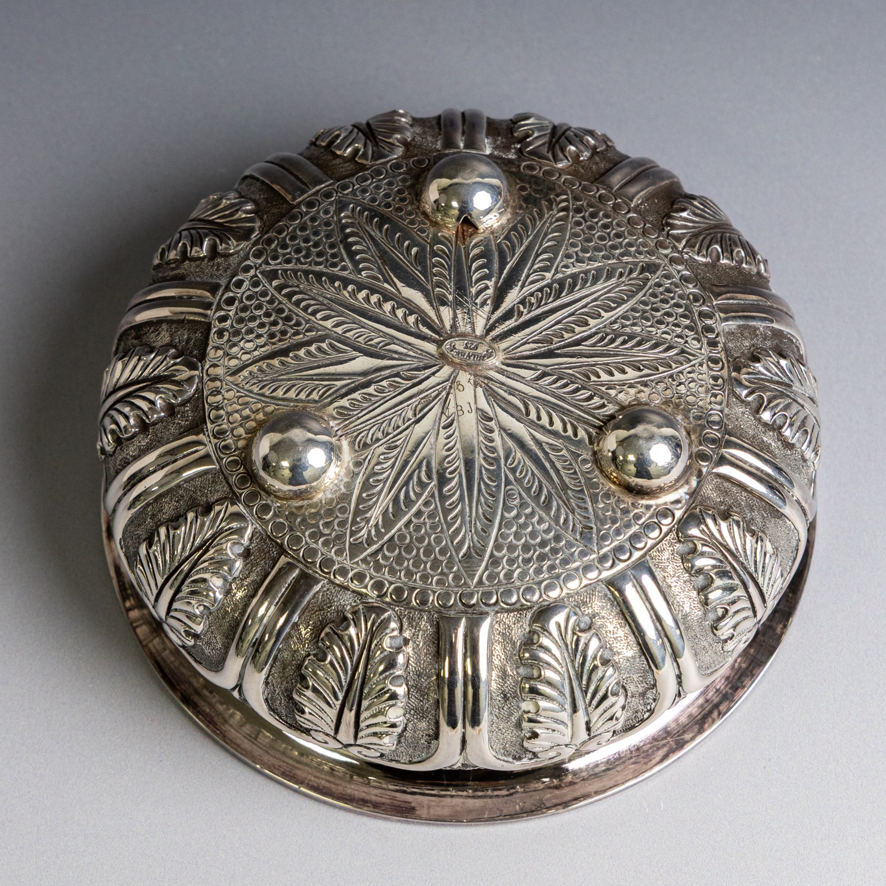 Indian silver bowl, of circular form with embossed acanthus leaf decoration, upon three bun feet, D5.5cm, H13cm
