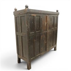19th century oak hutch cupboard, plank top with moulded cornice and turned finials, panelled front enclosed by two tiers of central double doors with iron hinges and wooden latches, flanked by fixed fielded panels, on stile supports