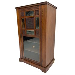 Edwardian walnut sheet music cabinet, the glazed door with floral carved panels and sectional bevel glazed mirrors enclosing four shelves
