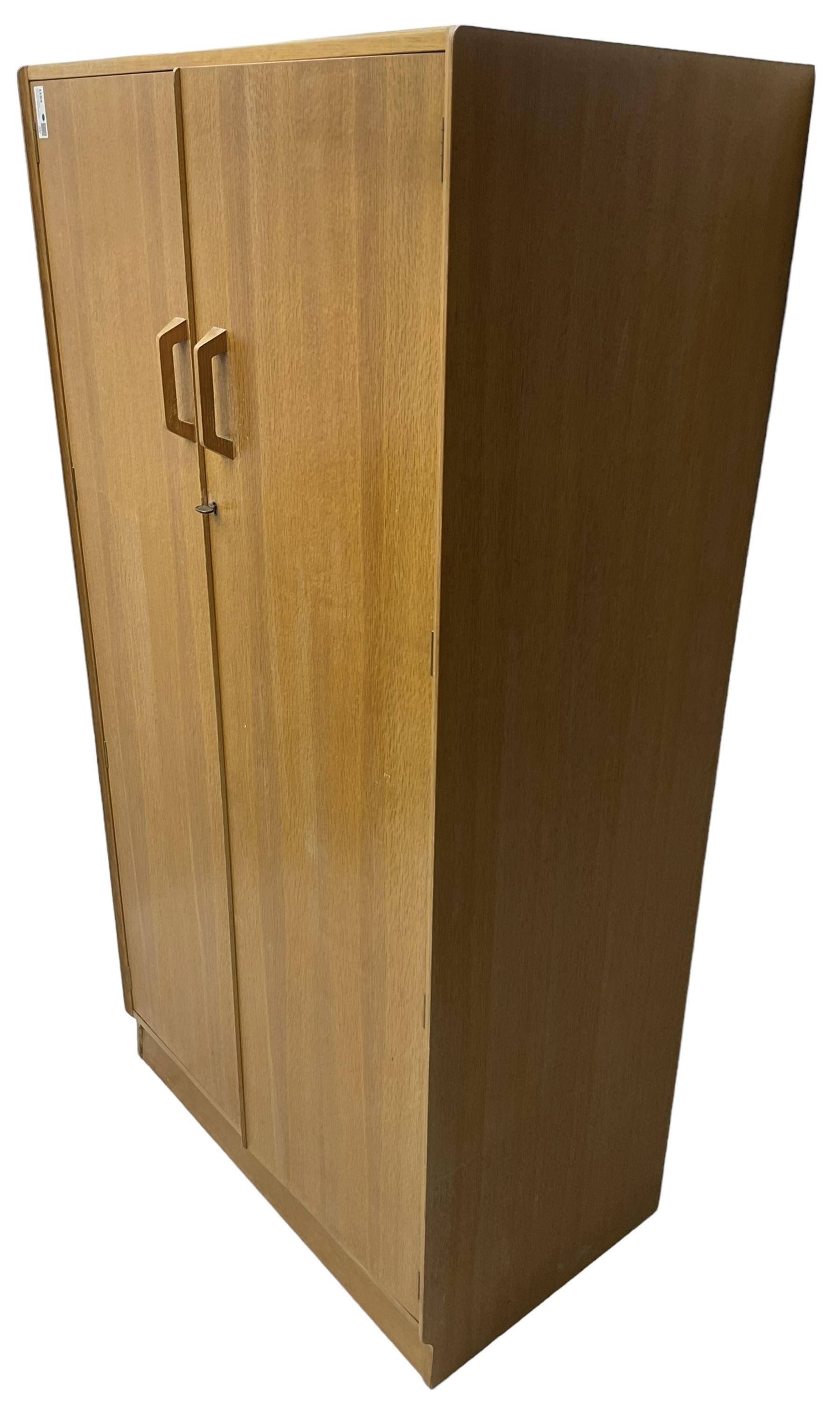 E. Gomme for G-Plan - 'Brandon' light oak double wardrobe, the interior fitted with hanging rail and shelves 