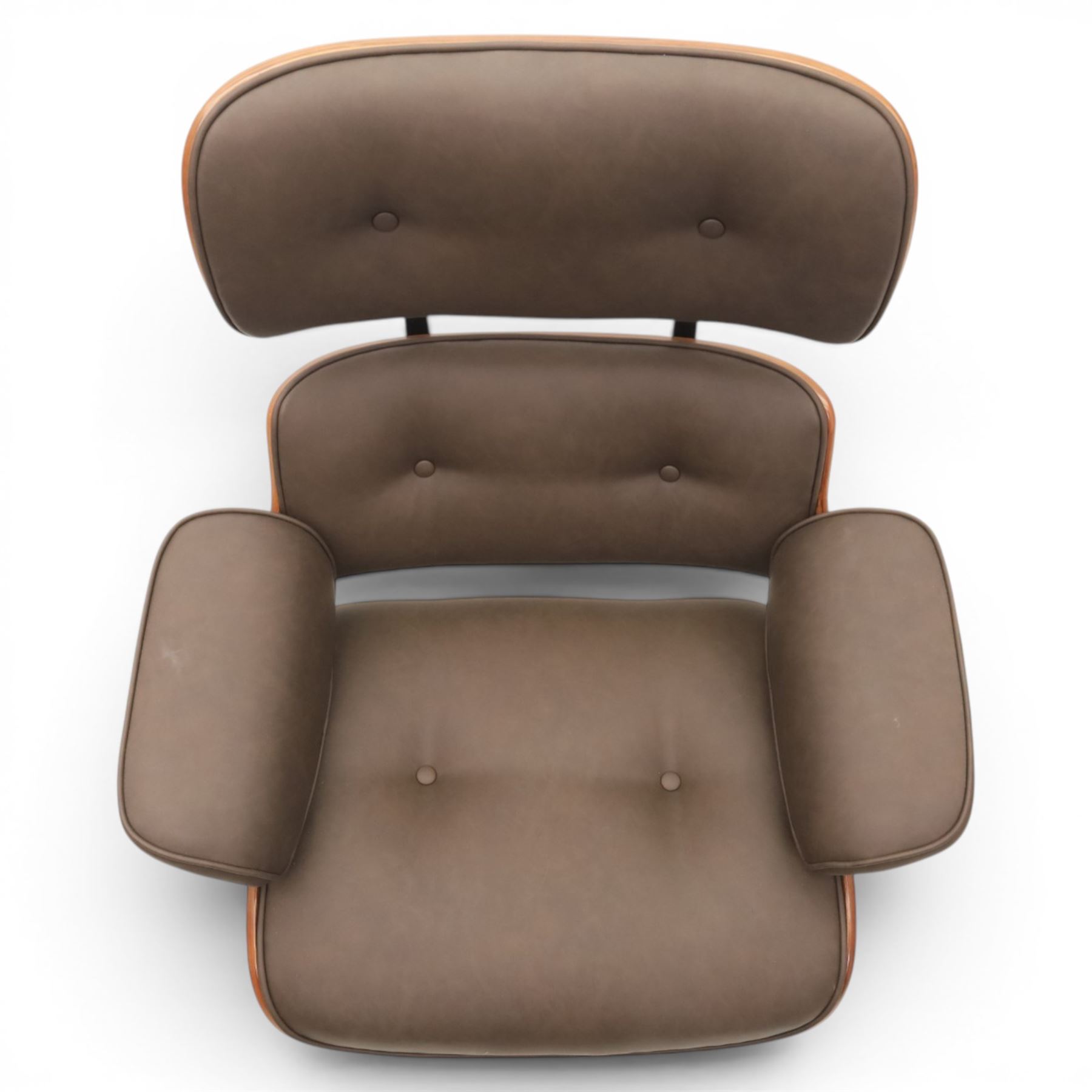 In the manner of Eames' Lounge chair, contemporary brown leather and plywood recliner and footstool, padded leather seat and arm rests, plywood backs raised on a black metal frames, reclines and swivels on a five point base  