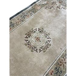 Chinese washed woollen camel ground rug, circular medallion surrounded by scrolls, the border decorated with birds and trailing floral decoration (248cm x 155cm); Chinese washed woollen pale green ground rug (125cm x 69cm); Persian design rug (186cm x 121cm) (3)