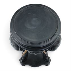 Elephant ebonised jardinière, moulded circular top raised on carved Elephant supports united by a shaped undertier