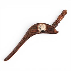 19th Century fruitwood goose-wing knitting sheath, decorated with geometric patterns, with a inset bone bust initialled A.B, together with a carved peg knitting stick, sheath L26cm