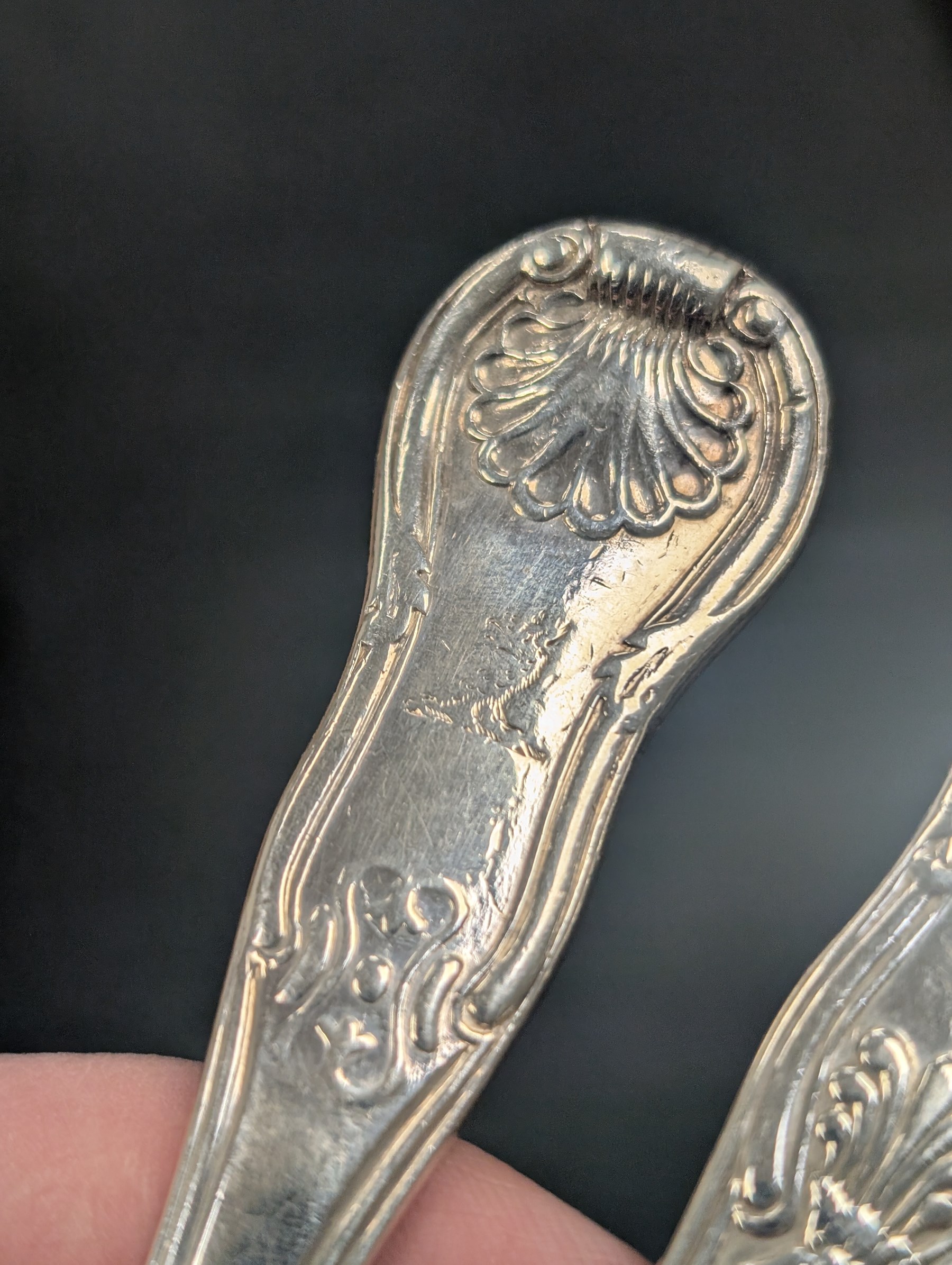 Seven silver Kings/Queens pattern dessert spoons, including George III Irish silver pair with engraved griffin crests, hallmarked Dublin 1818, maker's mark SI and five with varying dates and makers, all hallmarked 