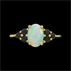 9ct gold opal and sapphire ring, single oval cut opal, with three sapphires set either sid...