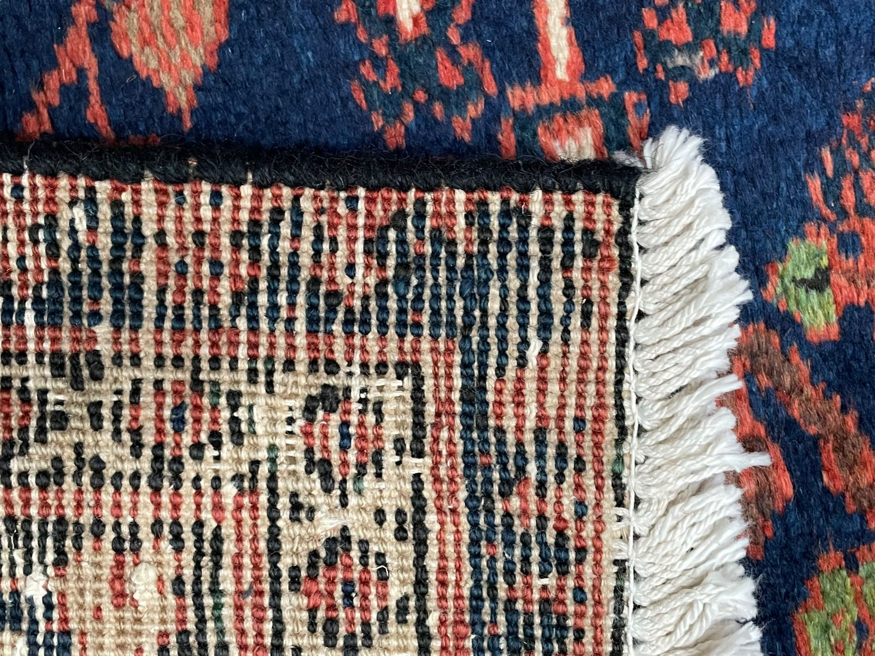 Persian Joshgan red ground rug, the medallion, field and spandrels decorated with clusters of Pitrak and tree of life motifs, the border with repeating design decorated with stylised plant motifs, within guard stripes