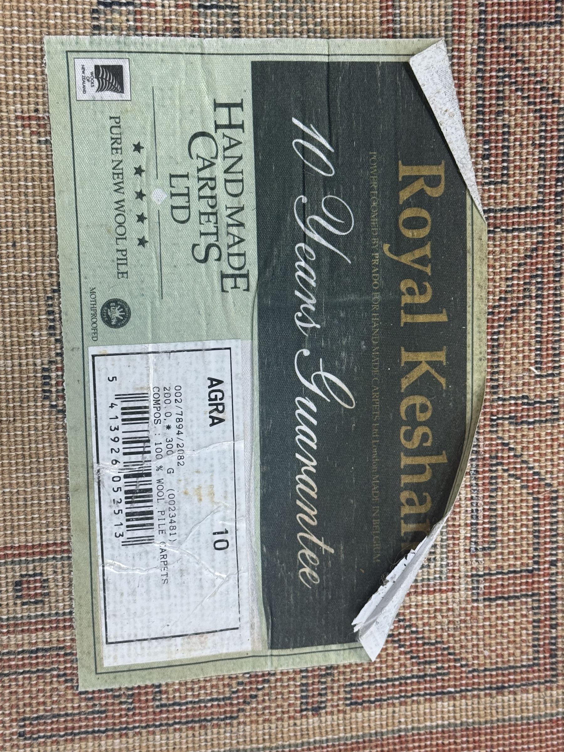 Late 20th century Royal Keshan 'Agra' hand-knotted wool rug, terracotta ground with central floral medallion and scrolling vines, enclosed by a cream border with repeating floral motifs