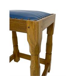 Brian Haw (former Mouseman carver) - Yorkshire oak stool, blue leather upholstered seat with stud band, on octagonal supports joined by plain stretchers