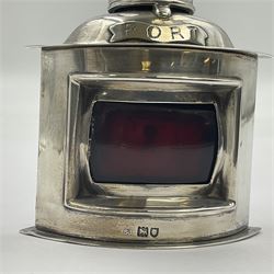 Early 20th century silver novelty inkwell, modelled as a ship's port lantern, with swing handle, convex red glass panel and hinged cover opening to reveal a glass liner, hallmarked Samuel Jacob, London 1911, height not including handle H8.5cm