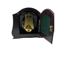 A Retro Art-Deco 1950's Bakelite cased mantel clock with a Smiths timepiece movement housed in a domed top case with curved sides on raised feet, dial with a cream chapter ring, upright Arabic numerals and minute markers, inscribed “Smiths, Made in Great Britain”, dial enclosed within a spun brass bezel and a convex glass, gilt pierced hands, spring driven 8-day pendulum movement. 
With pendulum.
