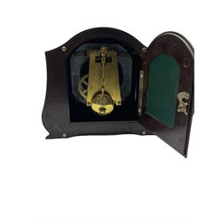 A Retro Art-Deco 1950's Bakelite cased mantel clock with a Smiths timepiece movement housed in a domed top case with curved sides on raised feet, dial with a cream chapter ring, upright Arabic numerals and minute markers, inscribed “Smiths, Made in Great Britain”, dial enclosed within a spun brass bezel and a convex glass, gilt pierced hands, spring driven 8-day pendulum movement. 
With pendulum.
