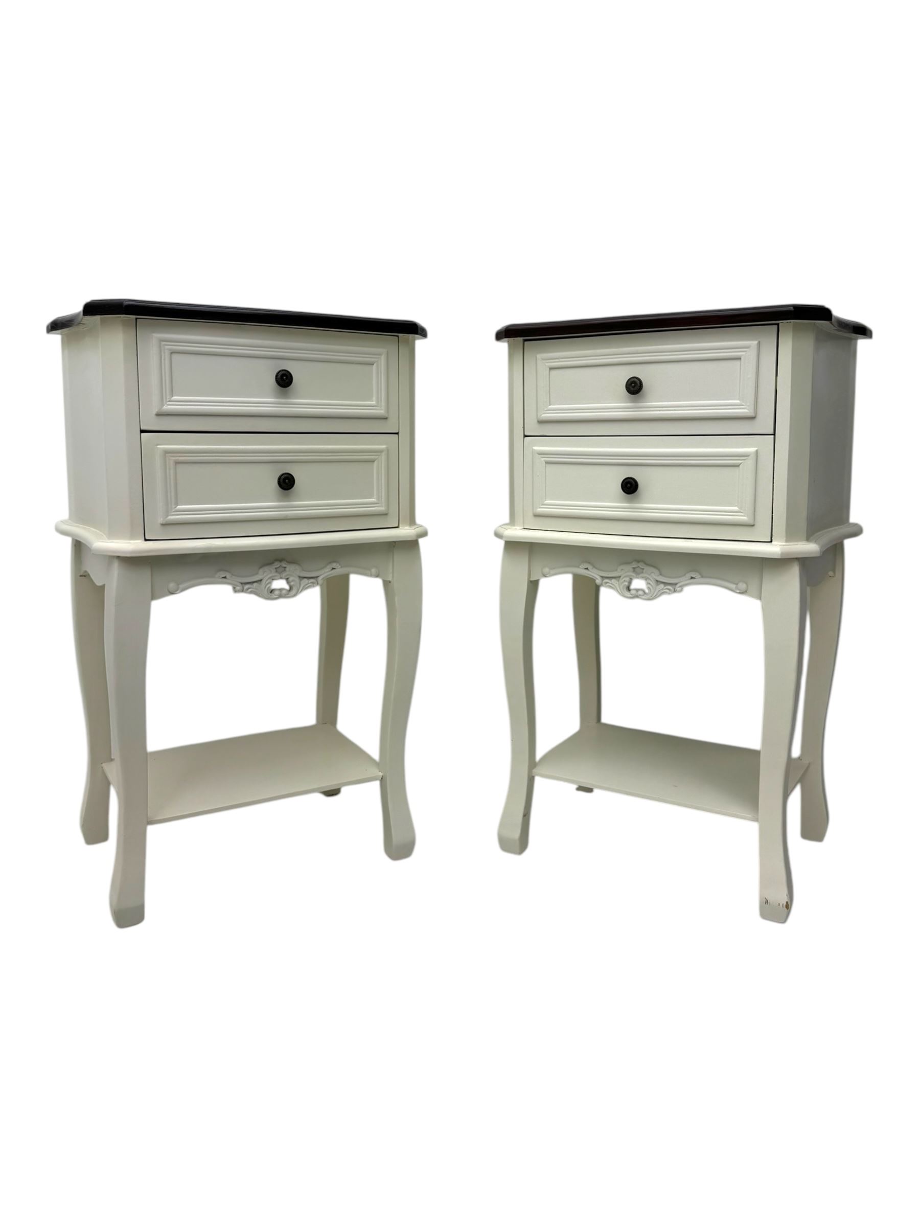 Pair of French design white painted bedside lamp tables, with painted wooden tops, above two drawers with carved apron and undertier, shaped legs  