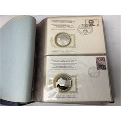 Thirty-six 'International Society of Postmasters Official Commemorative Issues' sterling silver proof medallic covers dating from 1975 to1977, housed in the official folder
