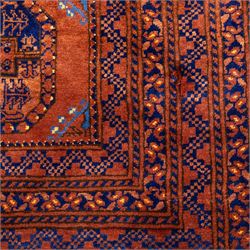 Pakistani Bokhara hand-knotted carpet, camel field decorated with rows of large tekke style octagonal guls enclosing stylized geometric motifs, interspersed with small stepped diamond devices within multiple geometric borders, with fringe ends 