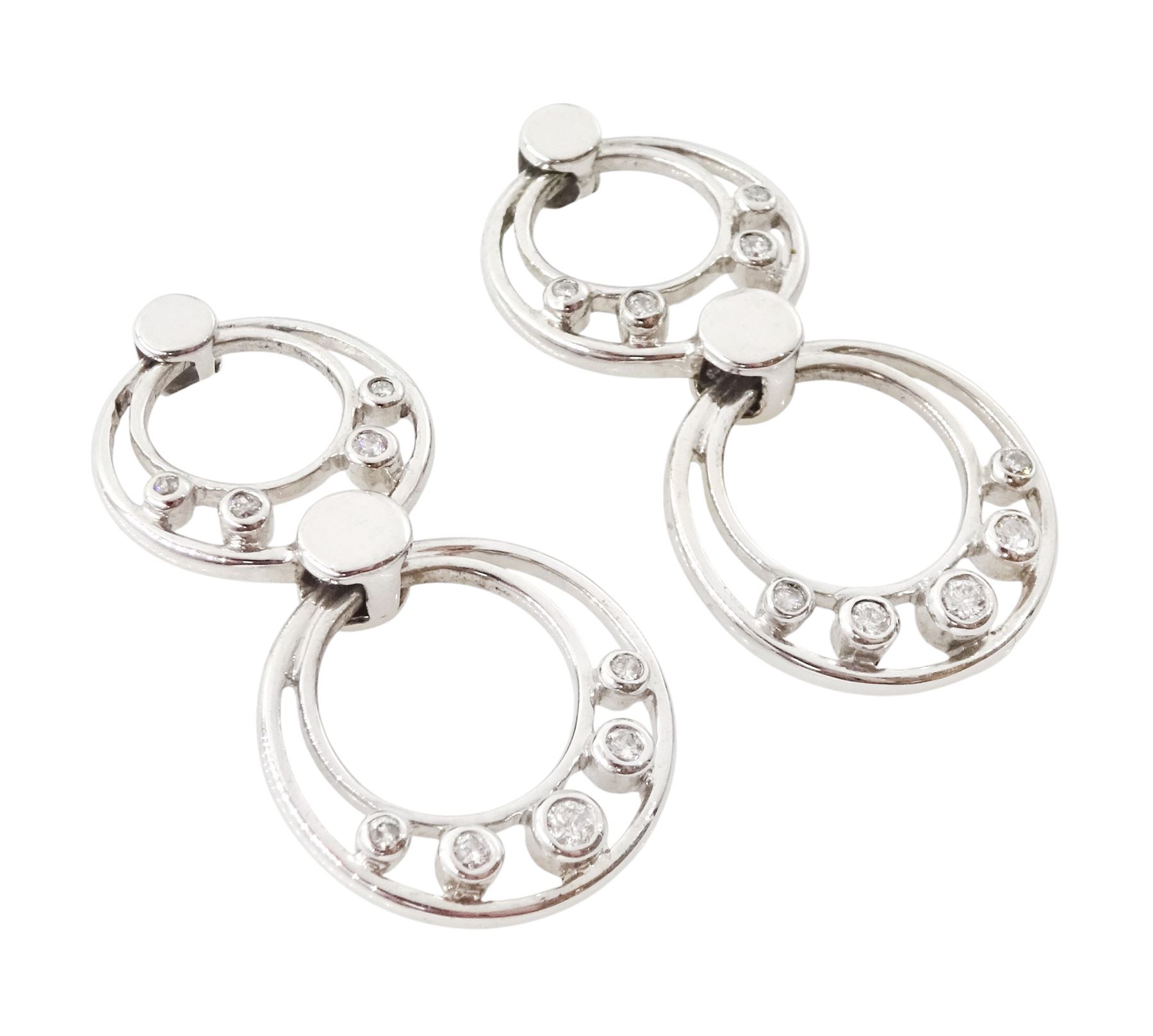 Pair of 9ct white gold diamond pendant earrings, each stud with two circular drops, set with nine round brilliant cut diamonds
