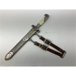German Reichsarbeitdienst RAD Leader's Hewer dagger, the 26cm single edged scimitar shaped blade with narrow fuller, etched Arbeit adelt; by E.D. Wusthof, Solingen; the aluminium hilt with spade and wheat ear langet; two piece white plastic grip and eagle head pommel; pebbled steel scabbard engraved with ears of wheat and strapwork with double leather hangers L40cm overall