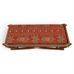 Traditional design teak long foot stool, red patterned seat cushion, on an X-frame base