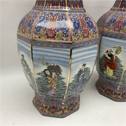 Pair of 20th century Chinese vases, of octagonal baluster form, each central panel decorated with one of The Eight Immortals, bordered by panels of floral motifs upon a pink/purple ground, H33.5cm